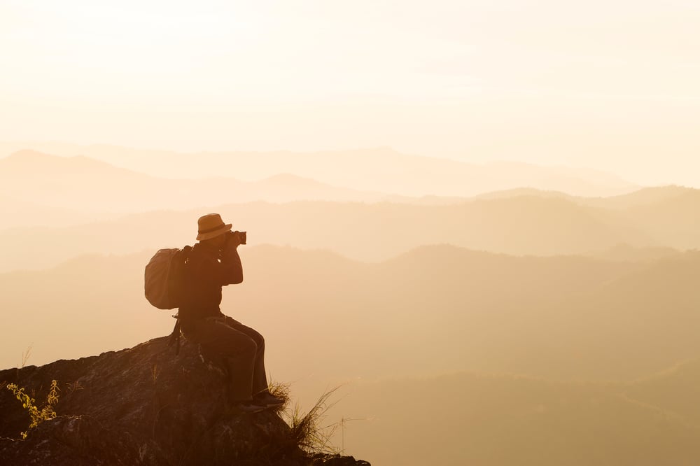 silhouette-man-hold-up-hands-peak-mountain-success-concept
